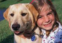 A Smiling Girl Taking Picture with Dog